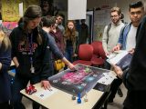 Student play board games developed by their classmates.