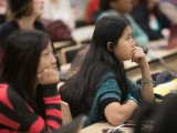 Several young women listen to a presentation during the Technovation Challenge.