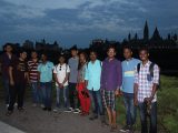 The visiting Indian students pose together at Major's Hill Park in the evening, with Parliament Hill in the backdrop.