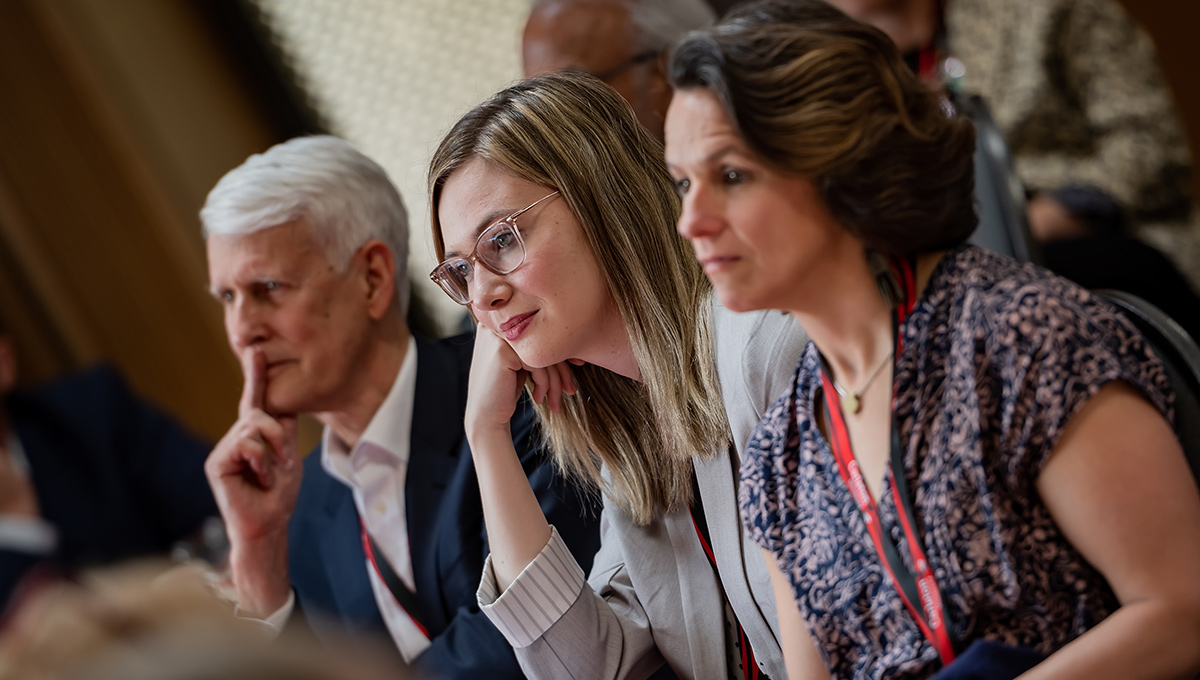 People in a crowd at a speaking event.