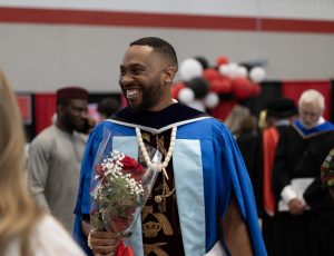 A recent graduate smiles after convocation.