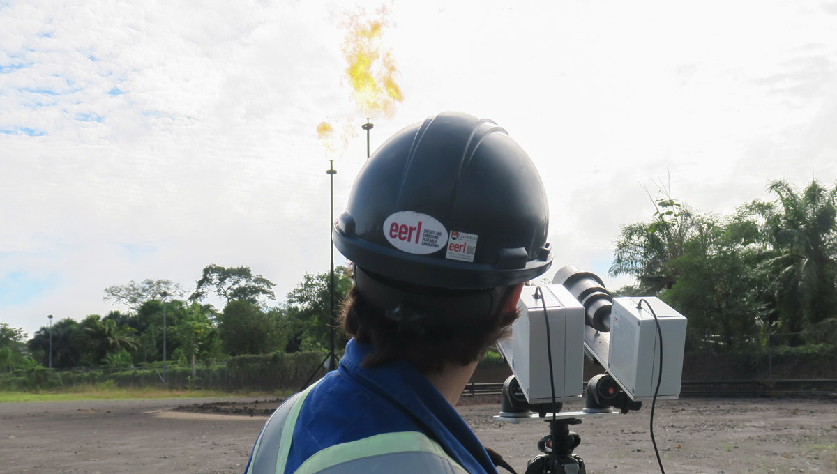 Matthew Johnson monitors a flare from afar using a remote sensing instrument.