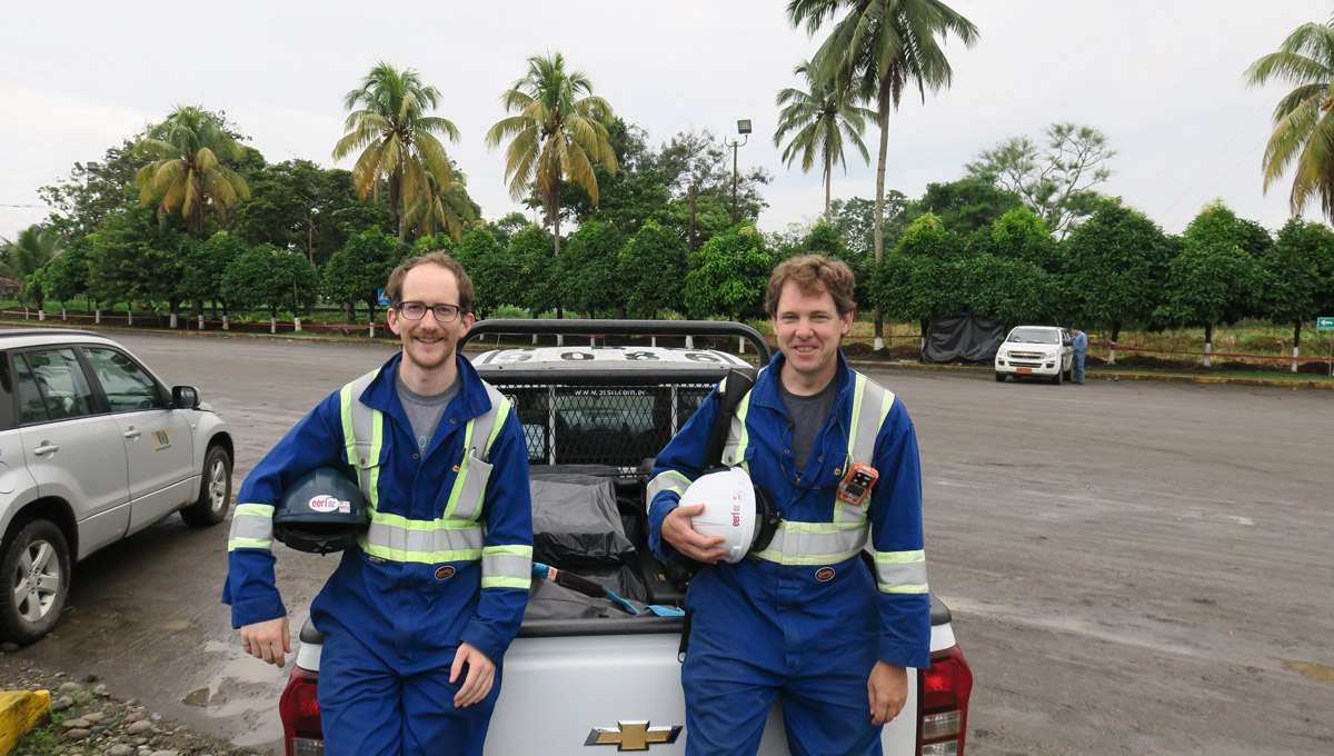 Members ot the FlareNet team lean up against a vehicle in Ecuador.