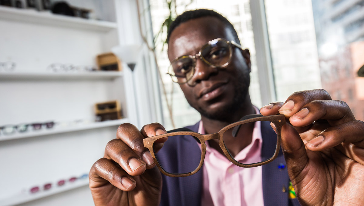 Nana Osei holds a pair of his sustainable glasses.