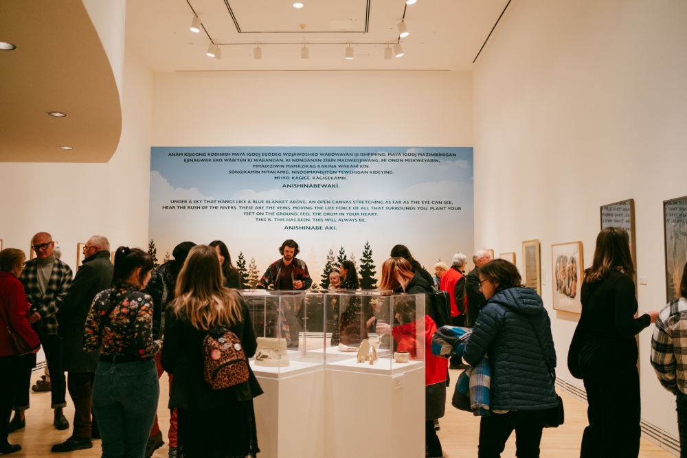 Group of people looking at art gallery exhibit. 