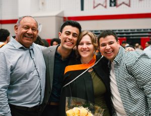 A recent graduate and her supporters smile for a photo in the Ravens Nest.