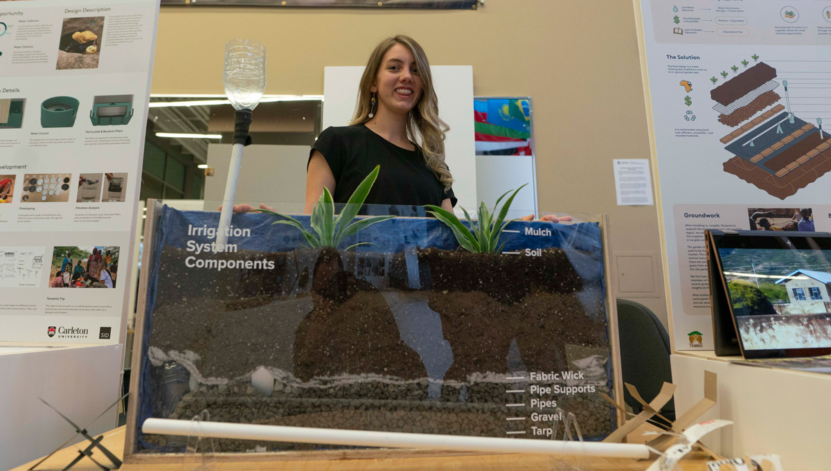 Carmen Cumming stands with her irrigation system.