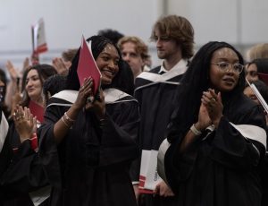 Students applaud at a convocation ceremony.
