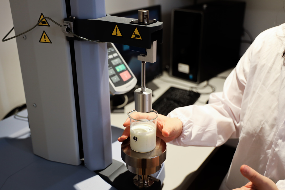 A researcher operates a 3D food printer.