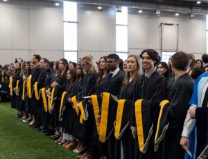 Students wait to cross the stage at their convocation ceremony.
