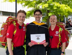 Graduating student Matthew Bacic poses with CUSERT team members.