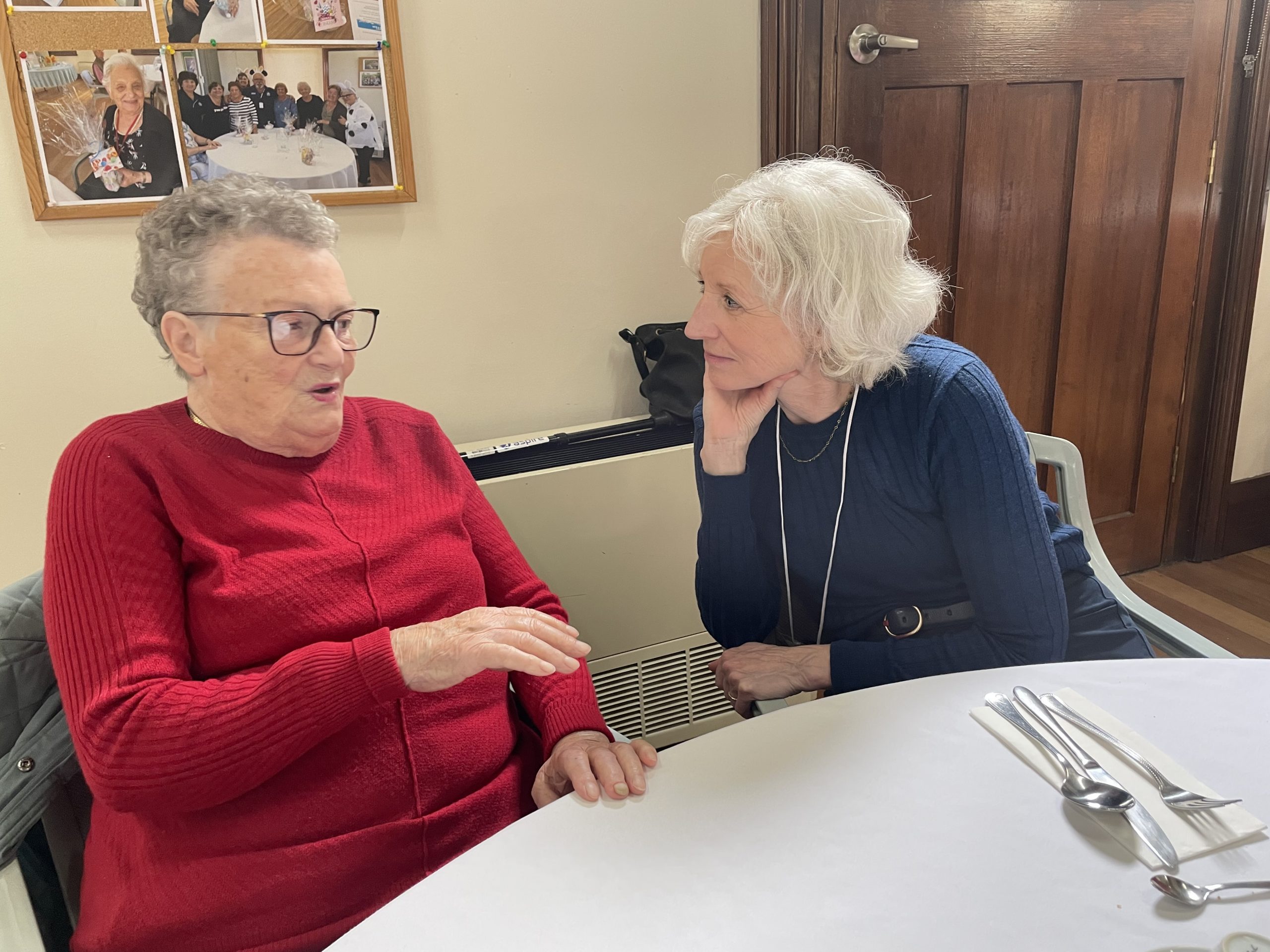 Two women having a conversation inside a long-term care facility