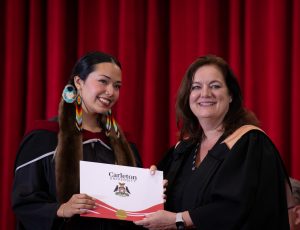 A student receives her degree at convocation.