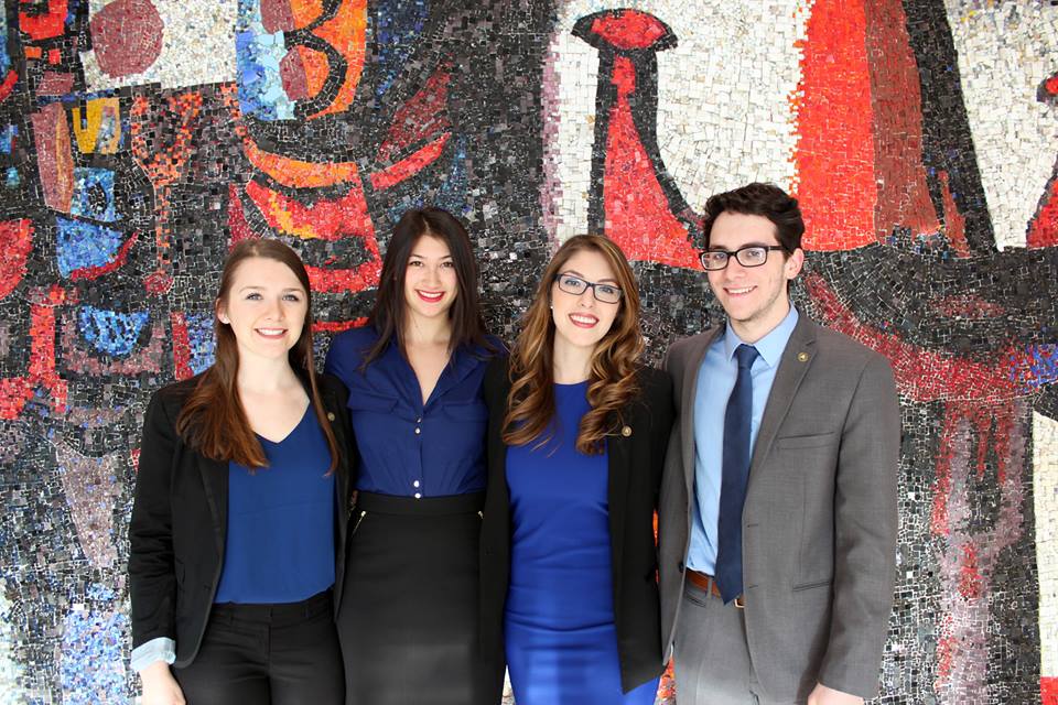 Cassie Lee poses in the foyer of the Tory Building with her Sprott Competes teammates.