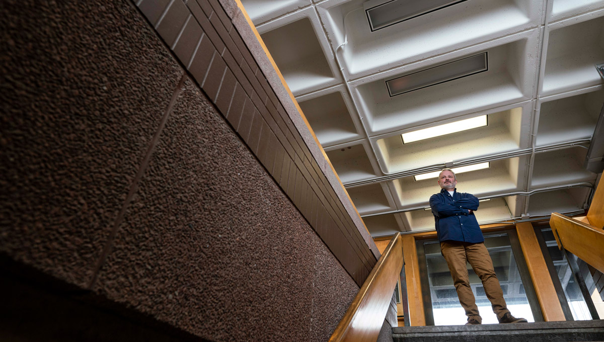 Discovery University instructor Matthew Sorley poses on a set of stairs.