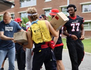 Volunteers help with move-in day.