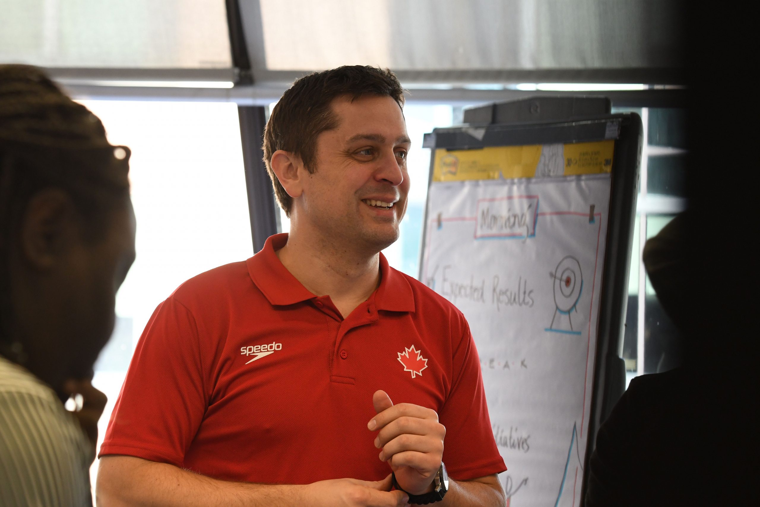 A man with brown hair and a red shirt