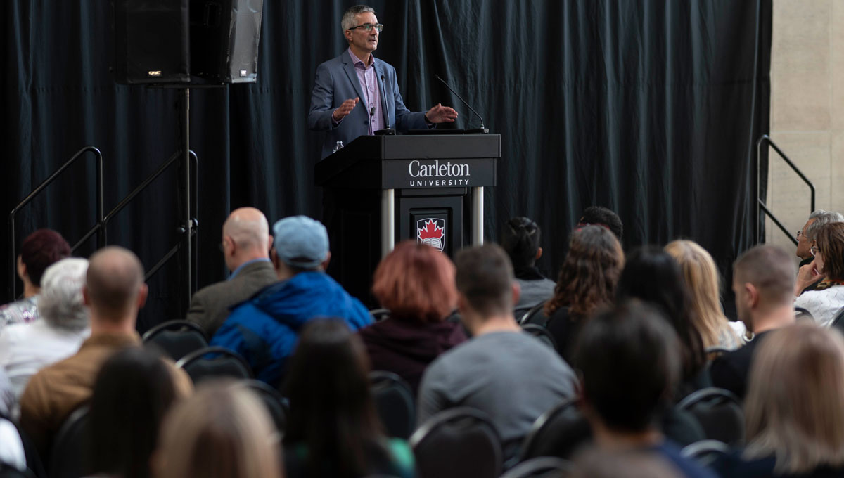 Michel Dugas speaks during his presentation at Psychology Mental Health Day.