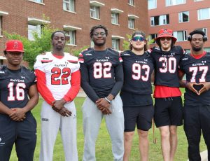 Ravens football players help with move-in day.