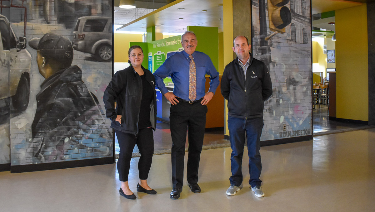 The Recycling Initiative team stands together in the cafeteria.