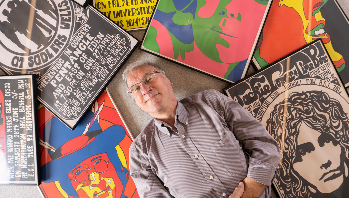 Brian Burns poses with his posters