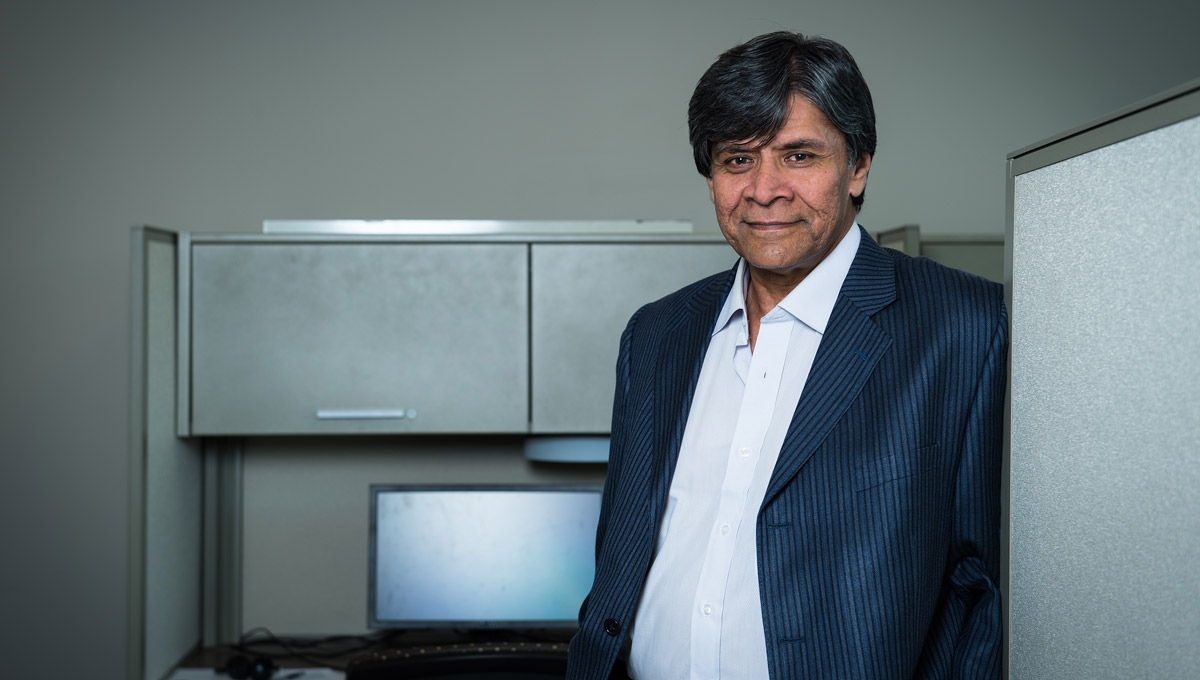 Prof. Shikharesh Majumdar poses in an office environment.