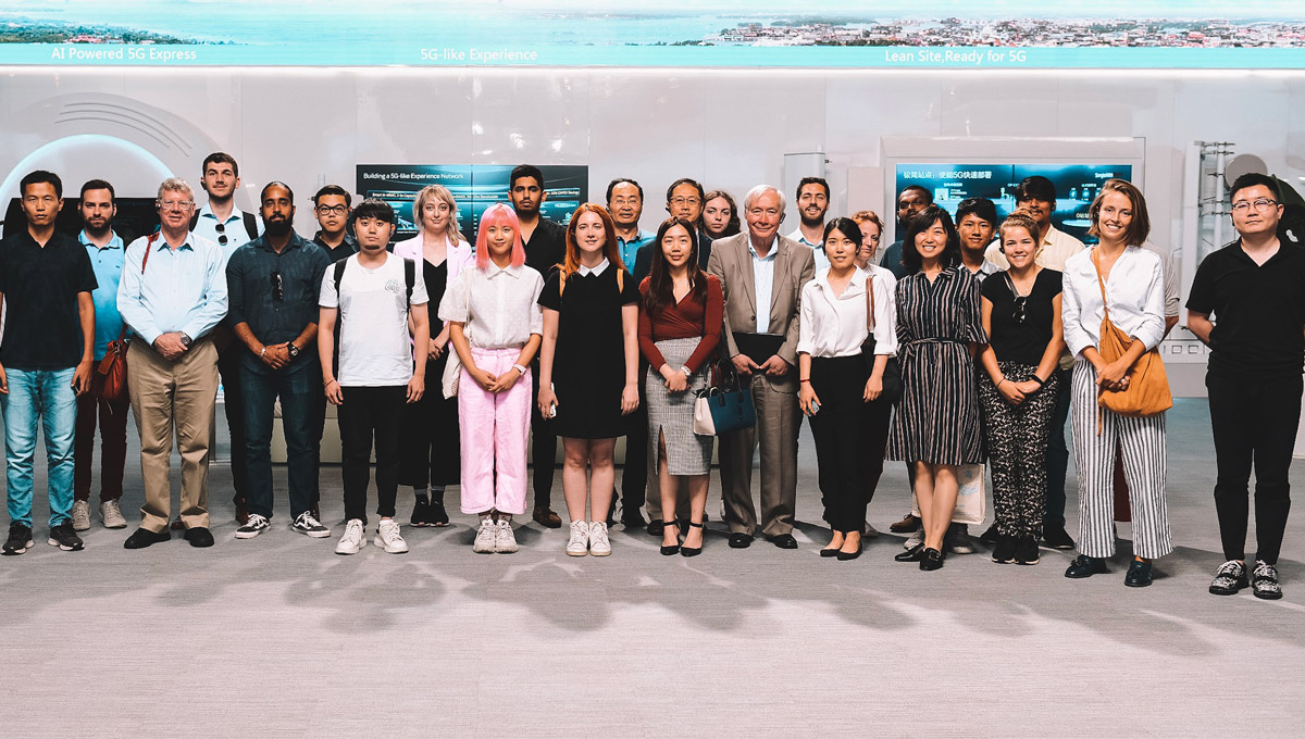 The Carleton delegation lines up and poses as a group in the lobby of a Chinese company.