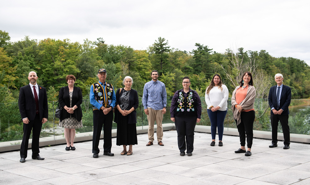 Members of the Carleton community associated with the Kinàmàgawin Celebration and Funding Announcement stand for a photo..