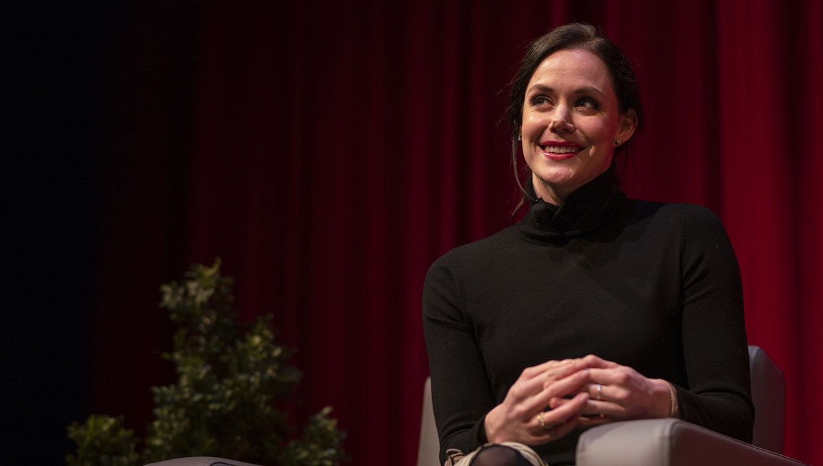 Tessa Virtue smiles at the audience from the stage.