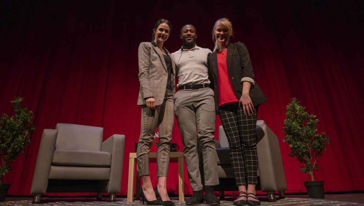 Tessa Virtue poses with two students onstage at the SOAR Student Leadership Conference.