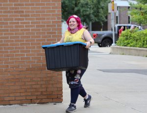 Volunteer helps with move-in day.