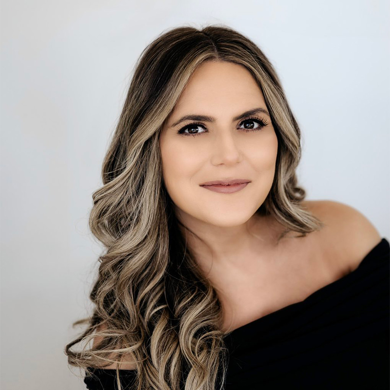 A professional headshot of a young woman, author of children's books..