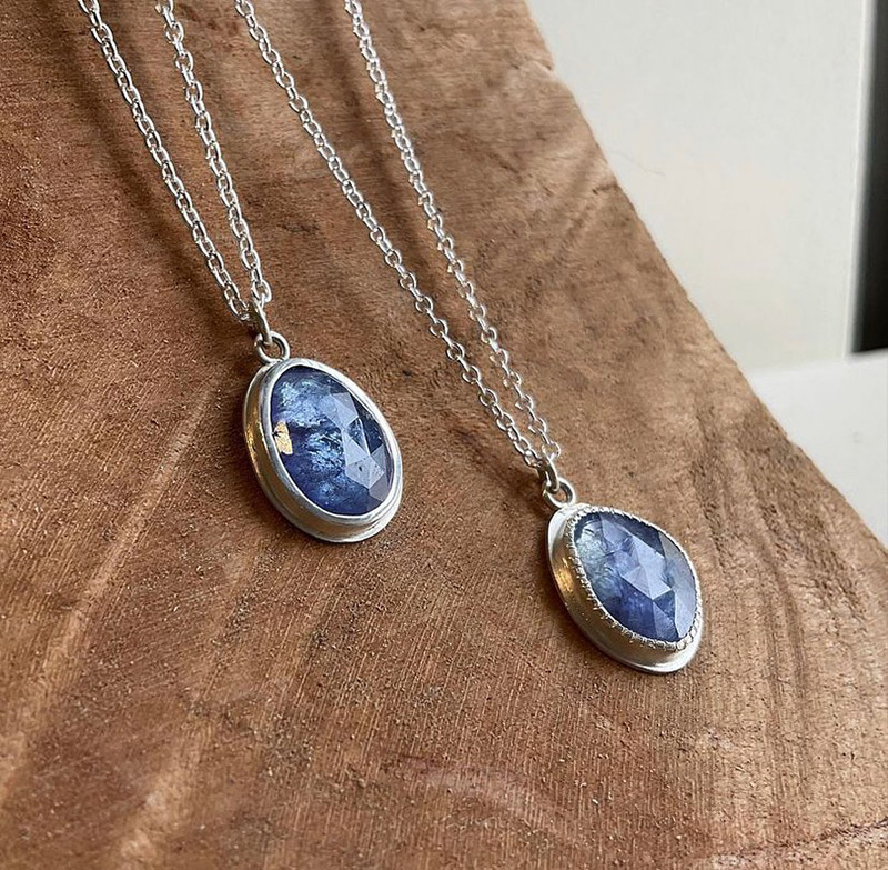 Two necklaces with blue diamonds.