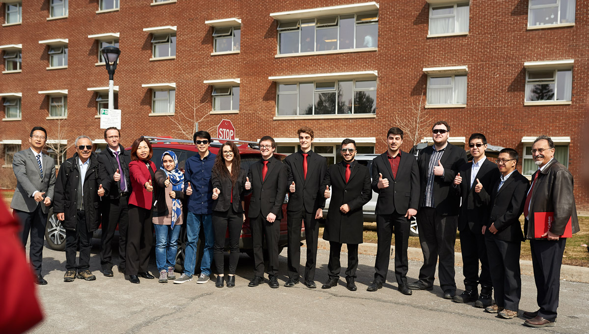 The autonomous vehicles test group poses together in a long line during the during the Autonomous Vehicles Test.