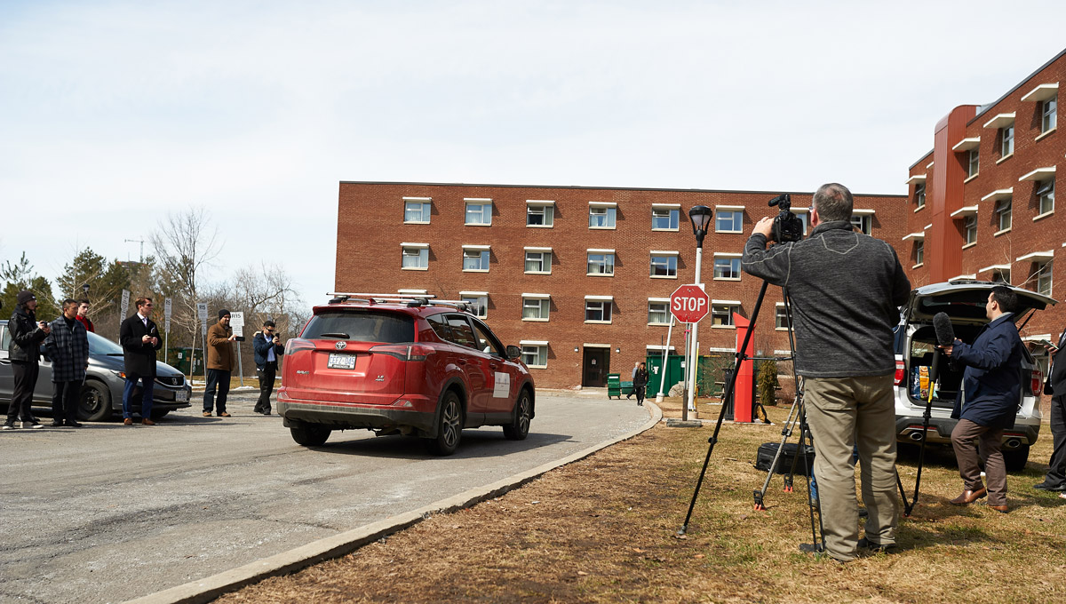 A vehicle navigates as onlookers watch during the Autonomous Vehicles demonstration.