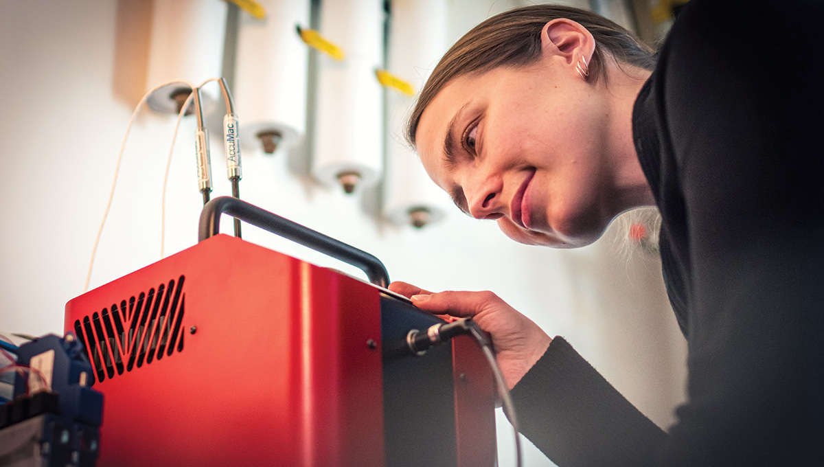 Cynthia Cruickshank examines a device in her lab.