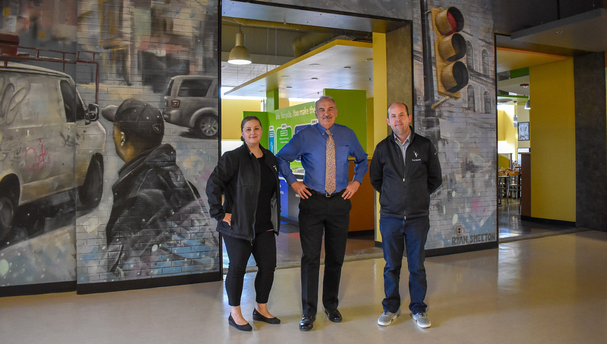 Sandra Nelson, Ed Kane and Chad McKenzie stand together in Carleton's food court.