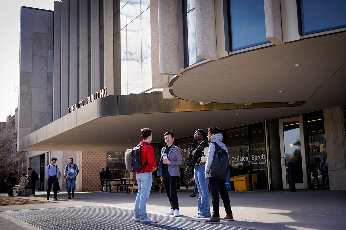 Students standing outside of an office building.