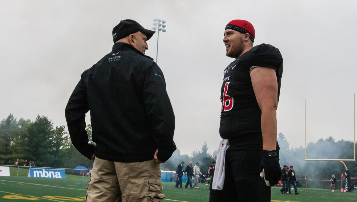 Coach Sumarah speaks with one of his players during a team practice.