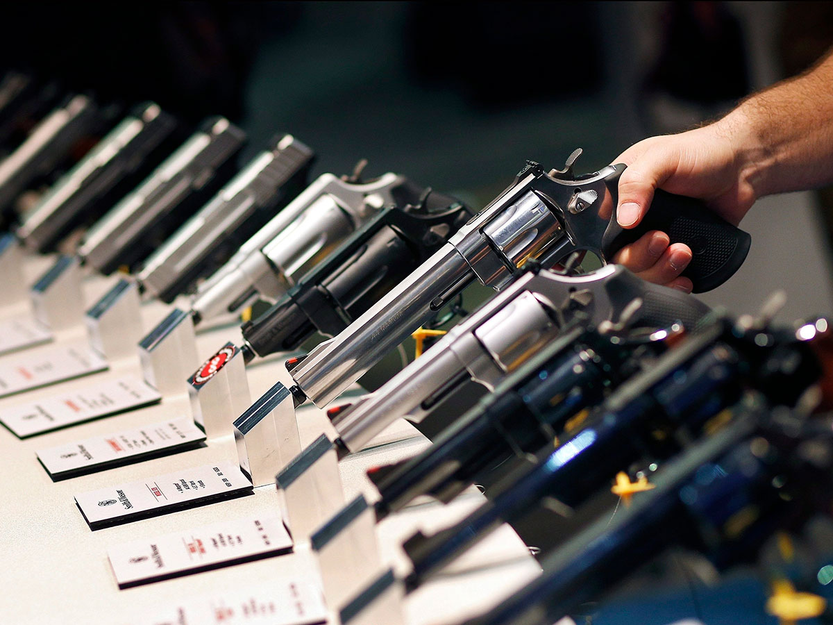 Handguns are displayed at the Smith & Wesson booth at the Shooting, Hunting and Outdoor Trade Show in Las Vegas. (AP Photo/John Locher)