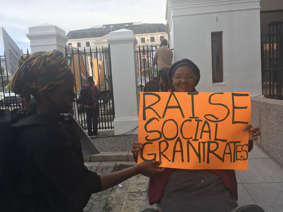 Social grant recipients rally outside parliament in Cape Town, South Africa calling for increases to grant rates in 2017. (Christopher Webb)