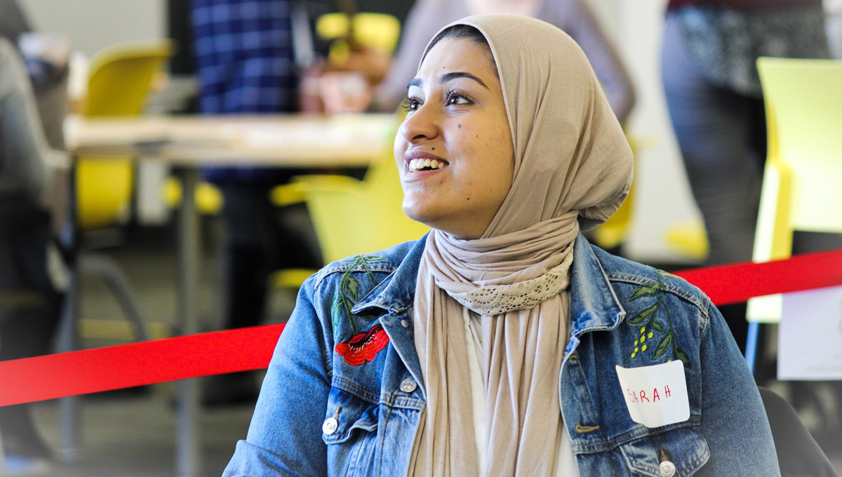 A student in a hijab networks with attendees during the conference.