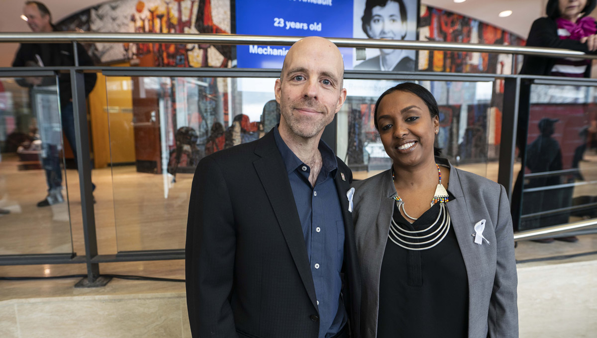 President Benoit-Antoine Bacon and Ikram Jama, Advisor on Human Rights and Equity, stand together in the Tory lobby.