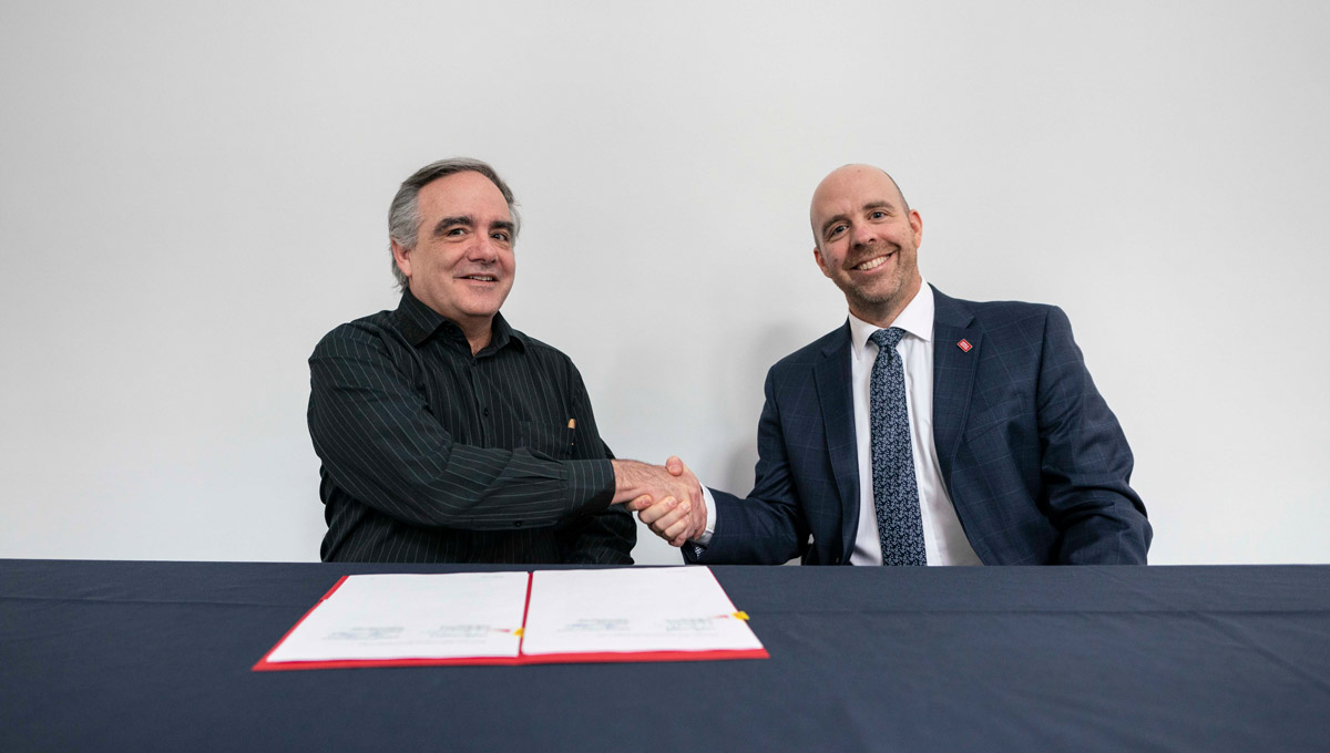 Carleton President Benoit-Antoine Bacon and Dominican University College President Maxime Allard sign a document renewing their Affiliation Agreement.