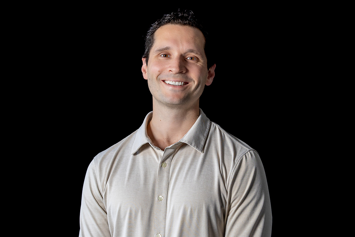 Professional headshot of academic Hubert Jean-Ruel over a black background.