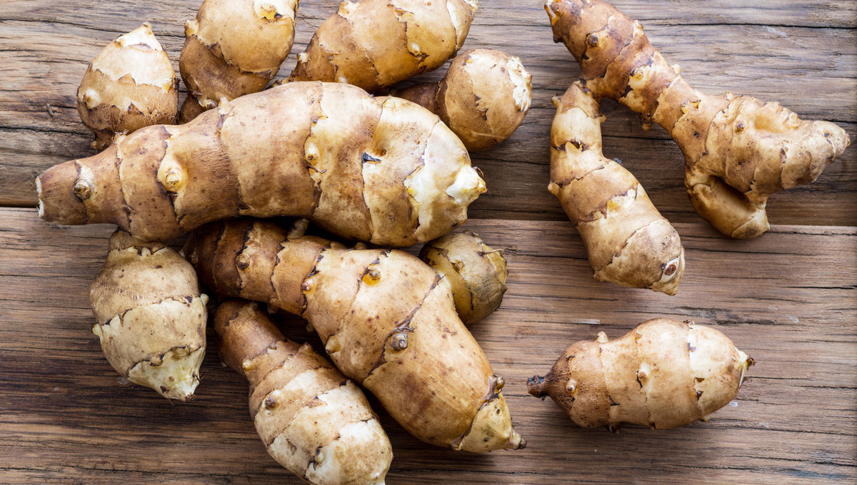 Jerusalem artichokes on a wooden table. Postdoctoral fellow Aynur Gunenc is exploring how to make processed meat products healthier using the nutritional properties of the Jerusalem artichoke.