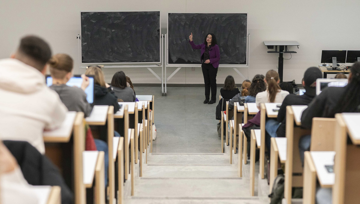 Dr. Kim Korace points to a blackboard/