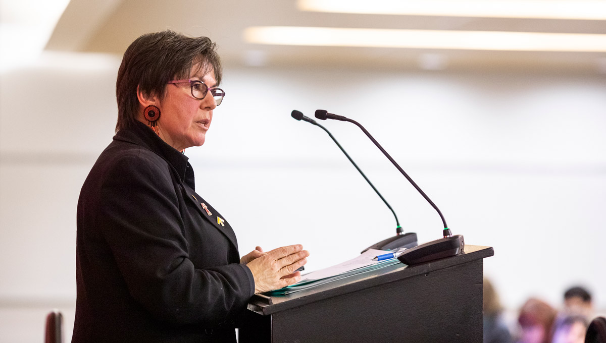 Kim Pate speaks at a podium