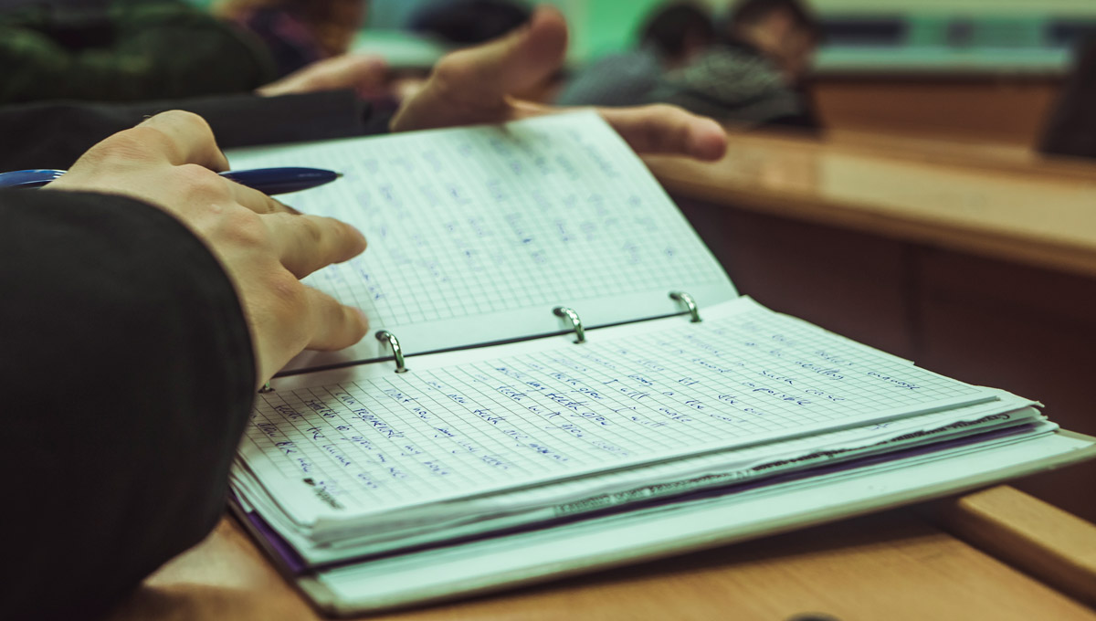 A student takes note during a lecture.