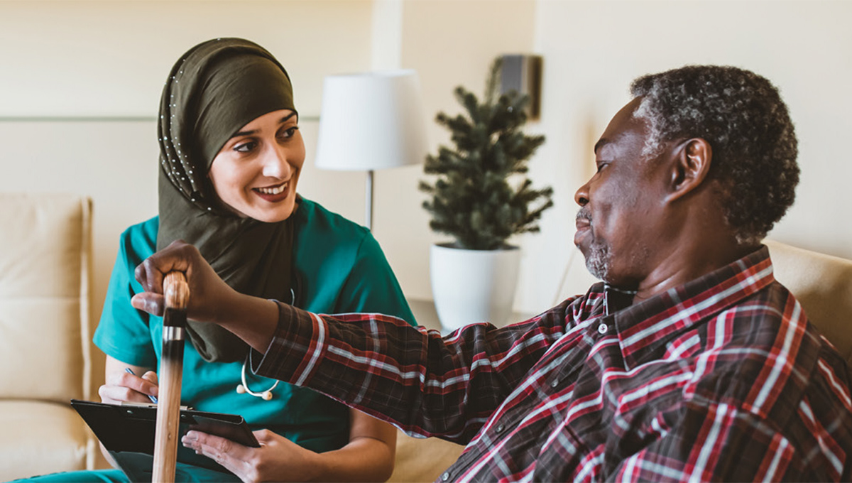 A woman helps an elder man